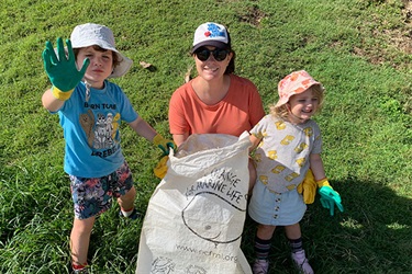 Woman and two children with rubbish bags for Clean Up Australia Day.