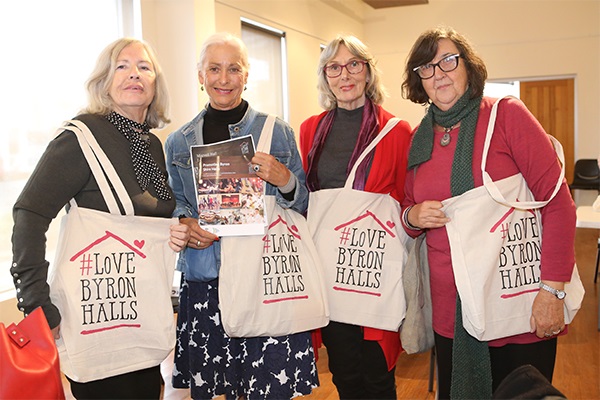 Women holding Love Byron Halls materials
