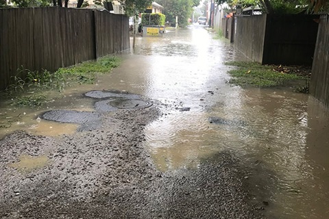Photo of water in drain and on road