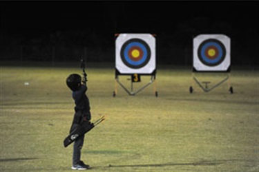 Child doing archery at the Cavanbah Centre