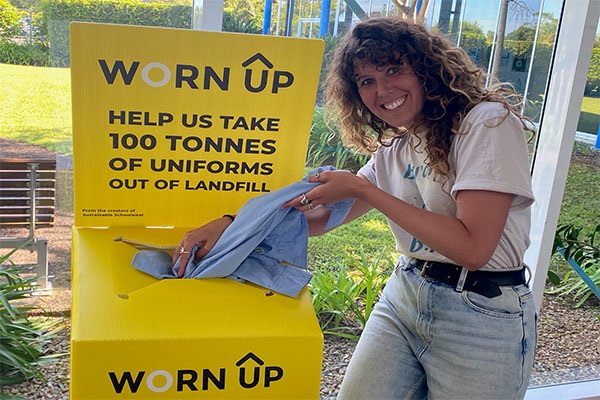 Sarah dropping off uniforms at the Worn Up recycling drop off point