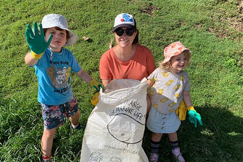 Lady and small boy and girl with rubbish bag