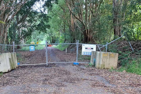 fences across road to show no access 