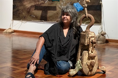 Person sitting on floor with sculpture