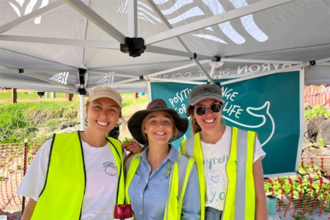 Council staff smiling whilst looking after a Clean up Australia information tent 