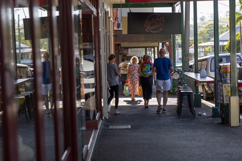 People walking down the main street of Bangalow, known for its hertitage shop fronts and character. 